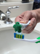 Load image into Gallery viewer, Shrek pooping toothpaste topper, product photo 1 of 8